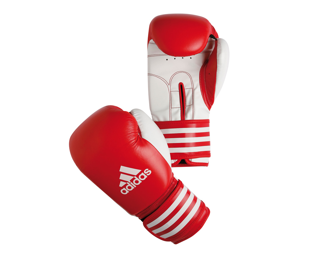 Перчатки боксерские Adidas Ultima Competition, цвет: красно-белый. adiBC02. Вес 14 унцийadiBC02 Перчатки боксерские Adidas Ultima Competition, цвет: красно-белый. adiBC02. Вес 14 унцийadiBC02Боксерские перчатки Adidas Ultima Competition для отработок ударов и комбинаций. Тыльная сторона в перчатках выполнена из прочной, износостойкой, натуральной кожи. Внутренний наполнитель, выполненный из формованной под давлением пены с интегрированной внутренней вставкой из геля, выполненной по технологии I-Protech, покрывает тыльную сторону, создавая надежную защиту рук и давая боксеру возможность безопасно тренироваться в полную силу. Внутренняя подкладка, выполненная из дышащего материала, и вентиляционное отверстие на ладони создают комфортный микроклимат внутри перчаток. Эластичный ремешок с фиксацией на липучке позволяет быстро одеть и снять перчатки.