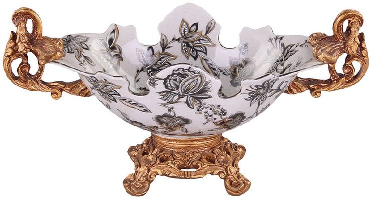 Фруктовница на ножке 33 см PATRICIAIM10-0406 Фруктовница на ножке 33 см PATRICIAIM10-0406Фруктовница на ножке выполнена из керамики. Изделие имеет сложную форму напоминающую распустившийся бутон цветка. Подставка изготовлена из полимерного материала имитирующего бронзу. Вся поверхность изделия украшена цветочным декором в классическом стиле.