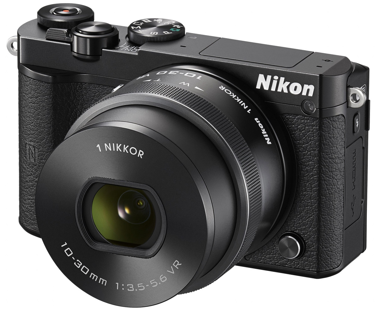 Nikon 1 J5 Kit 10-30 VR, Black цифровая фотокамераVVA241K001 Nikon 1 J5 Kit 10-30 VR, Black цифровая фотокамераVVA241K001Бросьте вызов обыденности с ультрапортативной системной фотокамерой Nikon 1 J5. Создавайте захватывающие 20,8-мегапиксельные изображения и удивительно резкие видеоролики с разрешением 4K. Благодаря исключительной скорости съемки, которая даже выше, чем у цифровых зеркальных фотокамер, вы не упустите интересный кадр.Ваши снимки будут выгодно отличаться от фотографий, снятых при помощи смартфонов, благодаря разрешению 20,8 мегапикселя. Фотокамера Nikon 1 J5 оснащена большой КМОП-матрицей и может использоваться с объективами 1 NIKKOR. Это отличный инструмент для реализации самых смелых творческих замыслов.При скорости 20 кадров в секунду с непрерывной автофокусировкой портативная фотокамера Nikon 1 J5 позволяет снимать сюжеты, недоступные даже для цифровой зеркальной фотокамеры. Благодаря режиму Спорт вы сможете запечатлеть самые стремительные движения и не упустите ни одного важного момента.Записывайте видеоролики сверхвысокой резкости с разрешением 4K? Создавайте неповторимые эффекты, замедляя ход времени с помощью плавного интервального видео или замедленной видеосъемки HD. Создавайте отличные фотографии одновременно с процессом видеосъемки.С легкостью размещайте лучшие снимки в социальных сетях. Фотокамера Nikon 1 J5 оснащена встроенным модулем Wi-Fi и поддерживает технологию NFC, что позволяет делиться высококачественными фотографиями быстрее, чем когда-либо, загрузив их через интеллектуальное устройство.Создавайте отличные фотоснимки и видеоролики. Касаясь сенсорного экрана с малым временем отклика, фотограф может фокусироваться, выполнять съемку и настраивать основные параметры. Поворачивайте экран вниз или вверх, чтобы снимать с необычного ракурса или создавать творческие автопортреты.Устройство так же удобно в управлении, как и цифровые зеркальные фотокамеры. К услугам пользователей диск выбора режимов PSAM, диск управления и кнопка Fn. Раскройте свой творческий потенциал и создавайте яркие изображения, запечатлев мир таким, каким видите его вы.