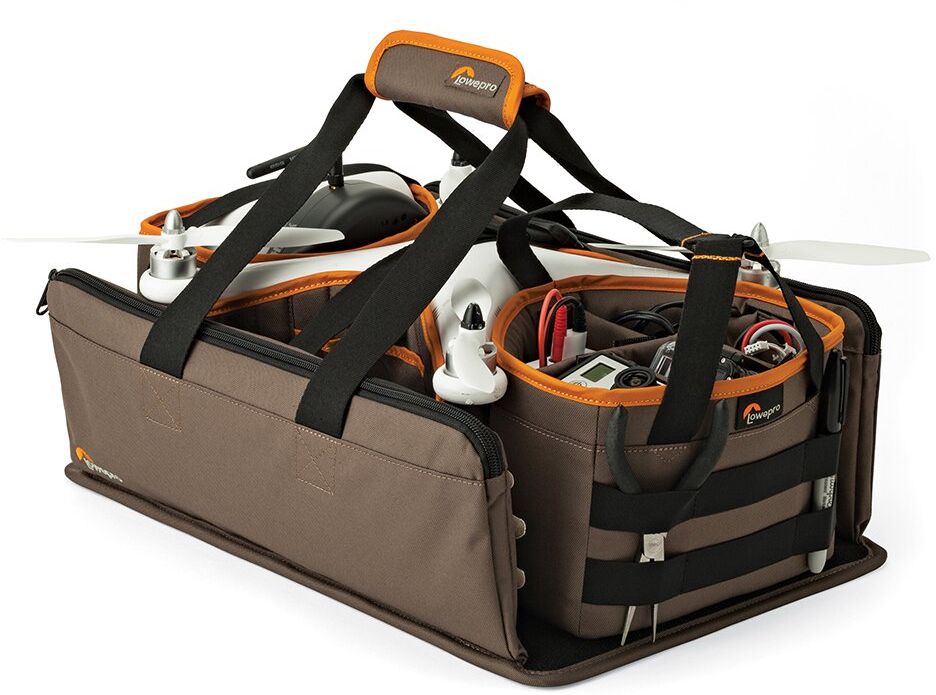 Lowepro DroneGuard Kit, Khaki сумка для дронаLP36910-PRU Lowepro DroneGuard Kit, Khaki сумка для дронаLP36910-PRUУльтракомпактная легкая сумкаDroneGuard Kit - это больше, чем просто сумка для нового вида техники, квадрокоптеров. Это комплексное решение для переноски, рассчитанное на модели, аналогичные DJI Phantom 1, 2, 3. Представляет собой каркас с твердым прочным основанием с закрепленными съемными отсеками и передвижными перегородками и удобными ручками для переноски. Сумка выполнена из прочного, износостойкого влагозащищенного материала. Модульный дизайн позволяет оперативно разместить квадрокоптер и аксессуары, и использовать сумку в собранном виде или отдельными элементами, в зависимости от условий и поставленных задач. В комплект входит отделение для батареек с передвижными перегородками, боковые отделения со специальными кармашками для хранения запасных лопастей и инструментов, отделение для пульта управления, передвижные съемные перегородки для безопасной транспортировки корпуса квадрокоптера. Функционально продуманный дизайн сумки позволяет удобно переносить и хранить технику, а также быстро подготавливать ее к работе. При разработке серии Lowepro DroneGuard дизайнеры Lowepro использовали огромный опыт в создании надежных, функционально продуманных решений для переноски фото-, видеотехники и гаджетов, а также подробно изучили ожидания владельцев квадрокоптеров и особенности их работы с этой техникой. В результате новая серия оптимально учитывает все нюансы переноски,защиты, транспортировки и хранения квадрокоптеров и аксессуаров к ним. Новая серия получила высокую оценку профессиональных пилотов-владельцев данной техники.