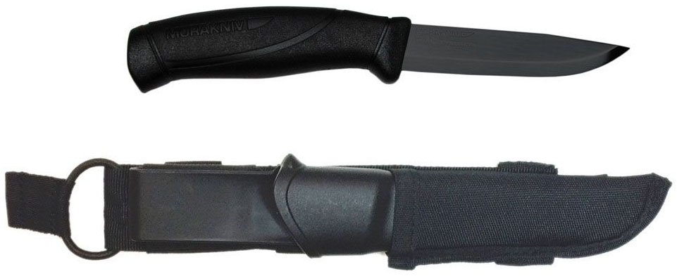 Нож туристический Morakniv Companion Tactical Black Blade, цвет: черный. 1235112351 Нож туристический Morakniv Companion Tactical Black Blade, цвет: черный. 1235112351Morakniv Companion Tactical BlackBlade - многоцелевой нож скандинавского типа известной торговой марки Mora of Sweden. Основная задача - приходить на помощь в любой ситуации. Он не удивит вас эстетикой внешнего вида, но никогда не подведет даже в сложных рабочих задачах.Более сбалансированную по параметрам цена-качество серию ножей найти практически невозможно. Mora Companion вызывает неподдельную радость от качества изготовления и легкости работы таким доступным инструментом. В них есть все необходимое, что наиболее часто бывает нужно при простой работе ножом: отличная геометрия и оптимальная длина лезвия, удобство рукояти и ножен, простота в уходе и неприхотливость.Morakniv Companion Tactical BlackBlade с клинком из нержавеющей стали Sandvik 12C27 твёрдостью 57-58 HRC - наиболее оптимальный выбор среди разнообразия моделей, ведь такой клинок требует наименьшего внимания и совершенно неприхотлив. Чёрное равномерное покрытие толщиной до 20 микрон, которое получено методом электроосаждения (под действием электрического тока). Рукоять ножа имеет двухкомпонентную структуру. Основу составляет нейлон усиленный стекловолокном, который с внешней стороны покрыт слоем противоскользящей резины, она имеет очень хорошее сцепление с ладонью и избегает проскальзывания в руке. Ее легко удерживать благодаря удобной форме и плавным изгибам. Простые, но в то же время, надежные ножны обеспечивают хорошее удержание ножа, внешнее нейлоновое крепление совместимое со стандартными PALS-стропами. Благодаря поясной петле их можно носить на ремне.