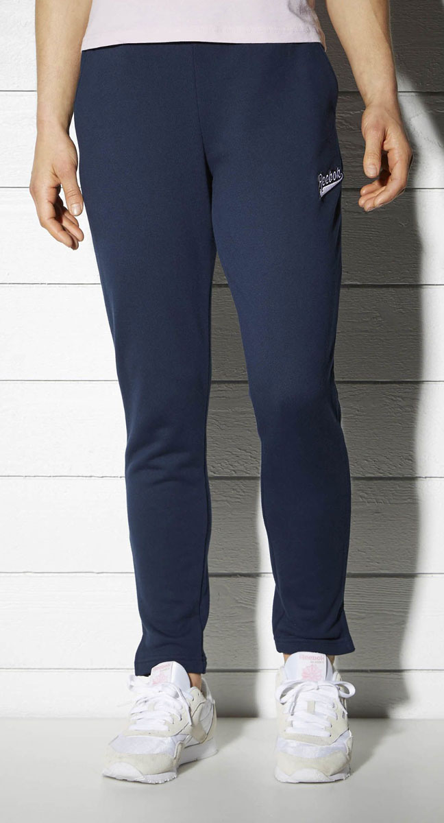Брюки спортивные женские Reebok F Varsity Knit Pan, цвет: синий. BK2495. Размер M (46/48)BK2495 Брюки спортивные женские Reebok F Varsity Knit Pan, цвет: синий. BK2495. Размер M (46/48)BK2495Спортивные женские брюки Reebok F Varsity Knit Pan - классический стиль. Мягкая объемная ткань очень приятна на ощупь, а разрезы по бокам создают дополнительный комфорт. Элементы классического дизайна и обработка швов тесьмой придают образу законченности. Свободный крой совершенно не сковывает движения.Эластичный регулируемый пояс на шнурке.Прямой крой штанин с разрезами по бокам.Декоративная тесьма в полоску добавляет винтажные нотки.Удобные карманы по бокам.