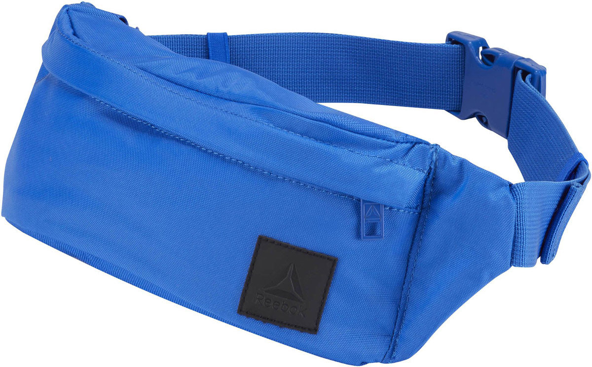 Сумка на пояс Reebok Style Found Waistba, цвет: синий. CD2181CD2181 Сумка на пояс Reebok Style Found Waistba, цвет: синий. CD2181CD2181Наденьте сумку Reebok Style Found Waistba на пояс и отправляйтесь навстречу приключениям. Внутри основного отделения на молнии есть несколько отсеков, куда можно положить телефон, бумажник и ключи. Регулируемый ремень позволяет носить сумку на поясе или на плече. Так, как удобно вам!Материал: 100% нейлон, легкий и в то же время прочный тканый материал.Размеры: 10.5 х 32 х 6 см.Удобный регулируемый ремень.Карман на молнии спереди.Потайной карман сзади.
