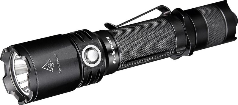 Фонарь ручной Fenix TK20R, цвет: черныйTK20R Фонарь ручной Fenix TK20R, цвет: черныйTK20RОписание фонаря Fenix TK20R Cree XP-L HI V3:Fenix TK20R — это действительно универсальный фонарь, который относится к классу тактических устройств. Он имеет сверхпрочный корпус из алюминия, подвергнутого анодированию Premium Type III. Этот корпус легко выдерживает отдачу от выстрелов или падение фонаря на камни с высоты одного метра. Он также полностью защищает все внутренние системы от намокания, обеспечивая водонепроницаемость степени IPX-8.Работает данная модель со светодиодом типа XP-L HI V3, который выпускает ведущий в этой области производитель — Cree. Такой диод в состоянии давать 1000 люмен света и освещать территорию в радиусе 310 метров. К тому же, он очень долговечный и прослужит по меньшей мере 50 тысяч часов.Fenix TK20R работает в пяти режимах. Помимо максимальной яркости, он также поддерживает освещение на 350, 150 и 10 люмен. Кроме того, доступен режим, в котором удобнее всего подавать световые сигналы, - стробоскоп. Его яркие вспышки видно на максимальном расстоянии.Данная модель работает с элементами питания двух типов: 18650 литий-ионные аккумуляторы и CR123A литиевые батарейки. В первом случае понадобится один единственный элемент питания, а во втором — два. Кстати, аккумулятор Fenix уже входит в набор к фонарю. Его емкость составляет 2900 мАч, чего хватит на период до 135 часов. Впрочем, этот срок можно увеличить еще, если приобрести более емкий аккумулятор.Производители предусмотрели популярную ныне возможность зарядки аккумулятора прямо внутри фонаря, для чего имеется разъем USB и подходящий к нему кабель. Время для зарядки — около 3,5 часов.Во время использования фонаря, уровень оставшегося заряда можно проверять. Для этого в Fenix TK20R встроен индикатор. Если он светится зеленым, то заряда осталось еще много, если же переключился на красный — фонарь вскорости потребуется зарядить. Мигающая красным лампочка индикатора сообщает о том, что зарядку необходимо подключить как можно скорее или же установить внутрь фонаря новый аккумулятор.Модель Fenix TK20R управляется двумя кнопками. В торце располагается та, которая включает его и выключает, а сбоку — кнопка для выбора нужного режима. Торцевую кнопку можно открутить и заменить дистанционной, которую нужно будет купить дополнительно. Такая кнопка удобна для охотников, которые могут прицеливаться и включать фонарь в одно и то же время. Также данная тактическая модель совместима с двумя вариантами креплений: на ружье и на руль велосипеда. Подходят к этому фонарю и многие другие дополнительные аксессуары, которые могут дополнительно расширить его функциональность.Особенности:фонарь дает свет яркостью 1000 люмен;интегрирован новый диод XP-L HI V3 (произведенный компанией Cree);фонарь работает в пяти режимах;радиус освещенной территории — до 310 метров;работа с аккумулятором 18650 или 2 батарейками CR123А;USB разъем для зарядки аккумулятора;возможность крепления на оружие или велосипед;совместимость со множеством аксессуаров;алюминиевый водонепроницаемый корпус;закаленное стекло с покрытием, не задерживающим свет;вес фонаря, не считая элементов питания, равен 141 грамм.Важно! Выносная кнопка совместима AER03, но только для включения, режимы второй кнопкой, как в ТК16 переключаться не будут!Гарантия: Любой из фонарей Fenix модели TK20R поставляется с официальной гарантией на 5 лет.
