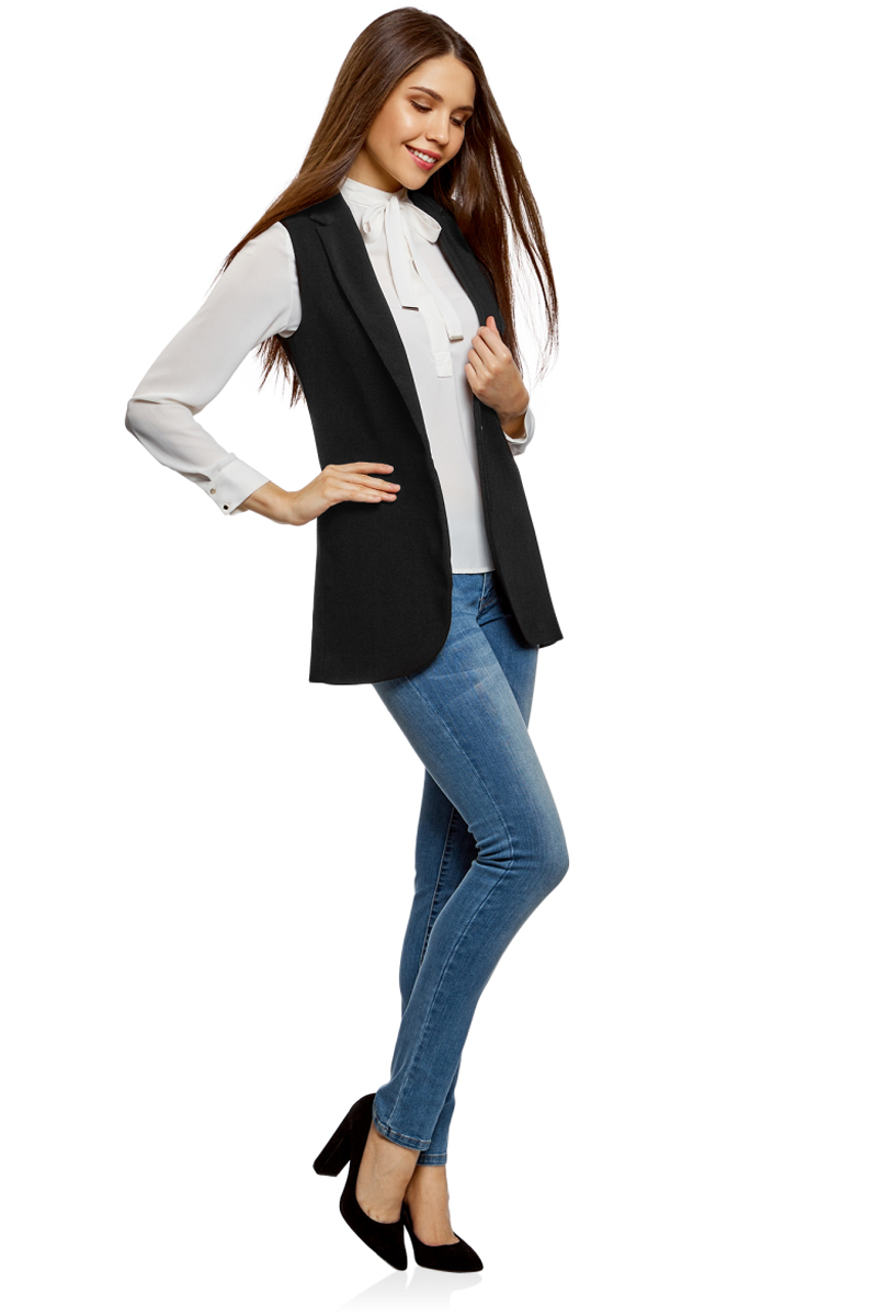 Жилет женский oodji Collection, цвет: черный. 22305005-4/47462/2900N. Размер 40-170 (46-170)22305005-4/47462/2900N Жилет женский oodji Collection, цвет: черный. 22305005-4/47462/2900N. Размер 40-170 (46-170)22305005-4/47462/2900NЭлегантный удлиненный жилет приталенного кроя. По крою жилет похож на классический удлиненный жакет с объемными лацканами, только без рукавов. Жилет отлично сидит на фигуре, визуально формируя силуэт. Эффектный жилет идеально подойдет для создания стильных деловых образов. В таком жилете можно пойти на работу, деловой ужин, официальную встречу. Он завершит ваш наряд в прохладную погоду. Это прекрасная замена надоевшему жакету или тренчу. Жилет красиво смотрится с классическими прямыми или зауженными брюками со стрелками и обувью на высоком каблуке. Под жилет можно надеть блузку, рубашку или любое тонкое трикотажное изделие с длинным рукавом. Изысканный и стильный жилет поможет вам разнообразить ежедневный гардероб.