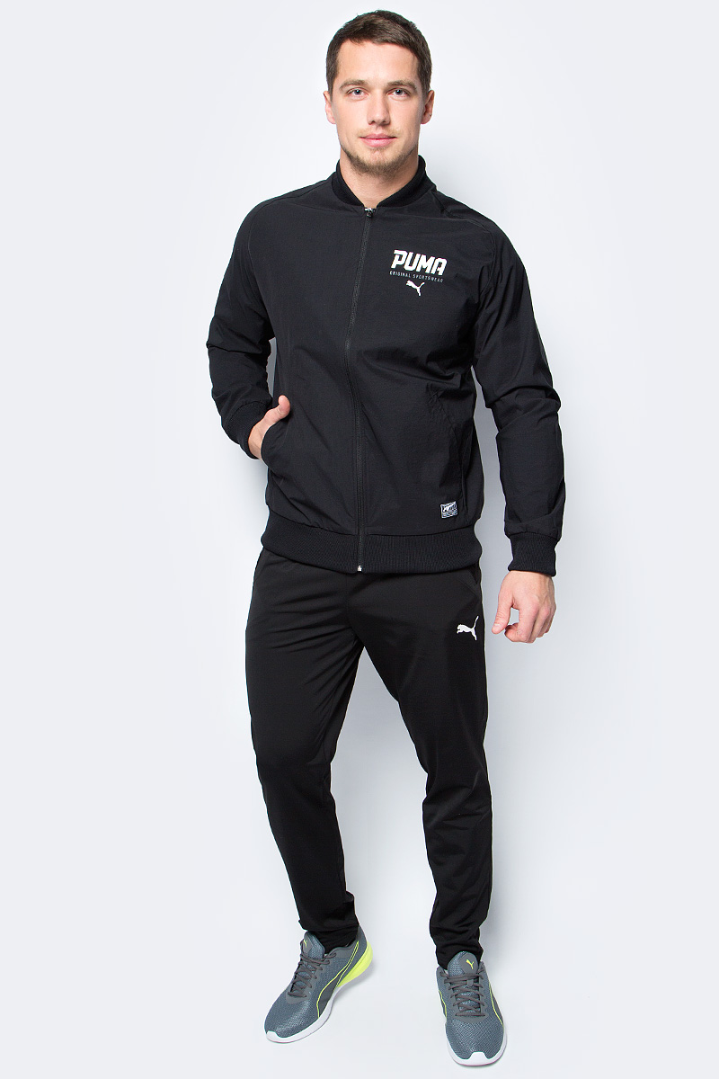 Куртка-бомбер мужская Puma Style Tec Stretch Bomber, цвет: черный. 59059901. Размер M (46/48)59059901 Куртка-бомбер мужская Puma Style Tec Stretch Bomber, цвет: черный. 59059901. Размер M (46/48)59059901Куртка STYLE Tec Stretch Bomber станет прекрасным дополнением спортивного городского стиля. Свободный покрой, эластичные манжеты, воротник и низ куртки, а также характерный ворот обеспечивают комфорт и отличную посадку по фигуре. Куртка изготовлена из легкого и эластичного материала. Спереди имеется застежка-молния и прорезные карманы с обтачками. Отделка швов на плечах выполнена матовой тесьмой. Рукава-реглан и боковые швы с нахлестом вперед обеспечивают полную свободу движений. Куртка декорирована графическим рельефным рисунком из прорезиненного материала и замши.