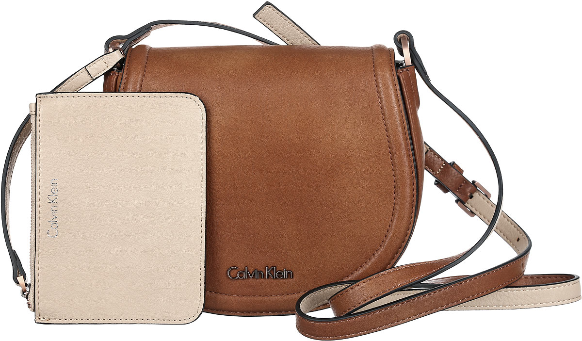 Сумка женская Calvin Klein Jeans, цвет: коричневый. K60K601646_9010K60K601646_9010 Сумка женская Calvin Klein Jeans, цвет: коричневый. K60K601646_9010K60K601646_9010Стильная сумка Calvin Klein выполнена из искусственной кожи с зернистой фактурой, оформлена металлической фурнитурой с логотипом бренда.Изделие содержит одно отделение, которое закрывается клапаном на магнитную кнопку. Внутри сумки размещены накладной кармашек для мелочей и врезной карман на застежке-молнии. Сумка оснащена практичным плечевым ремнем регулируемой длины. В комплекте с изделием поставляются небольшой кошелек на застежке-молнии, который фиксируется к сумке при помощи карабина, и чехол для хранения.Модная сумка идеально подчеркнет ваш неповторимый стиль.